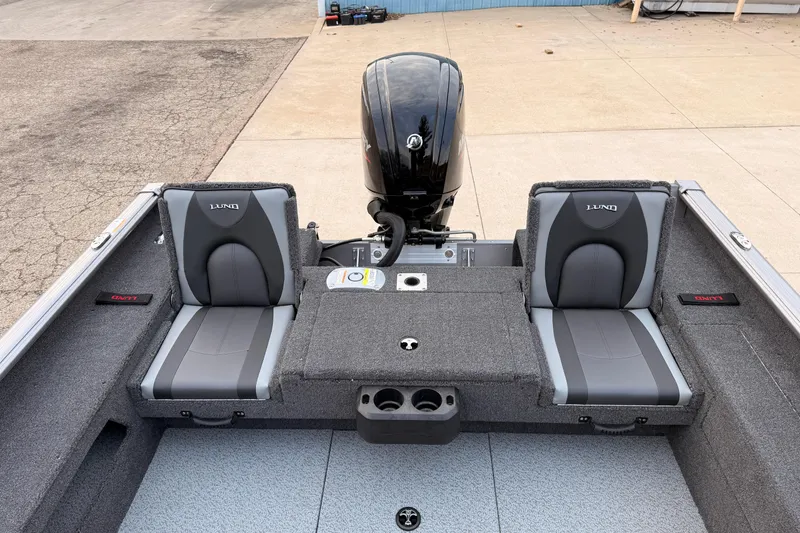 Slide: The Image of 2026 Lund 1775 Impact XS SS boat interior with dual seats and motor. - 24