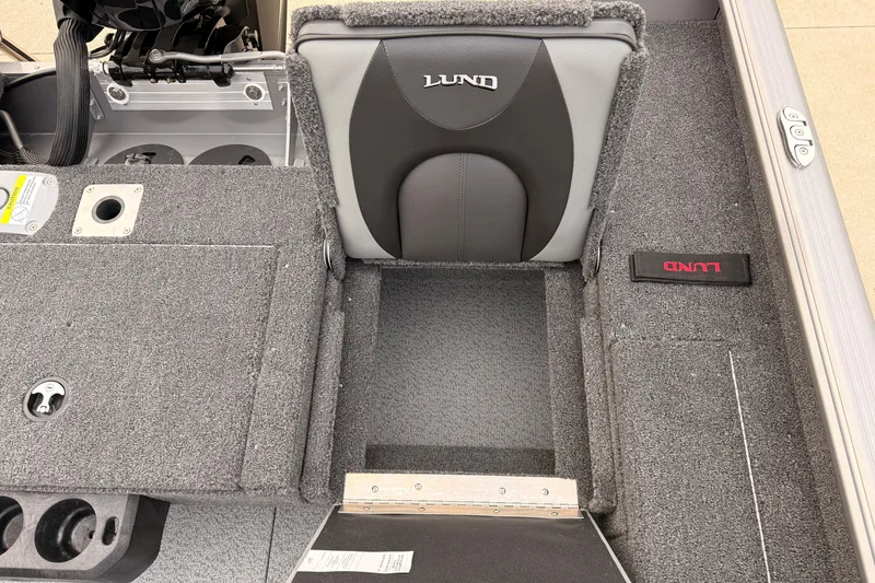 Slide: The Image of 2026 Lund 1775 Impact XS SS boat interior with gray seating and storage compartments. - 25