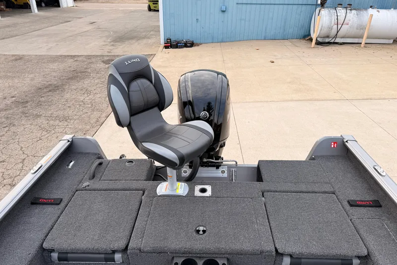 Slide: The Image of 2026 Lund 1775 Impact XS SS boat interior with seating and motor. - 28