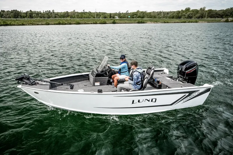 Slide: The Image of 2026 Lund 1775 Impact XS SS boat on trailer outside showroom. - 3