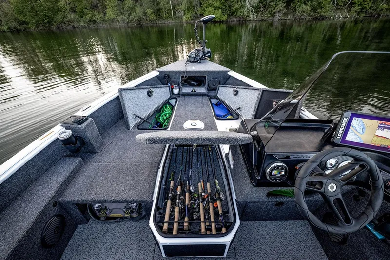Slide: The Image of 2026 Lund 1775 Impact XS SS boat with Mercury 115 engine, parked outdoors. - 6