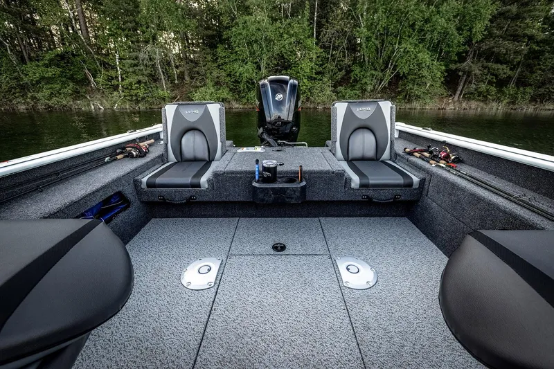 Slide: The Image of 2026 Lund 1775 Impact XS SS boat with Mercury 115 engine, parked outdoors. - 8