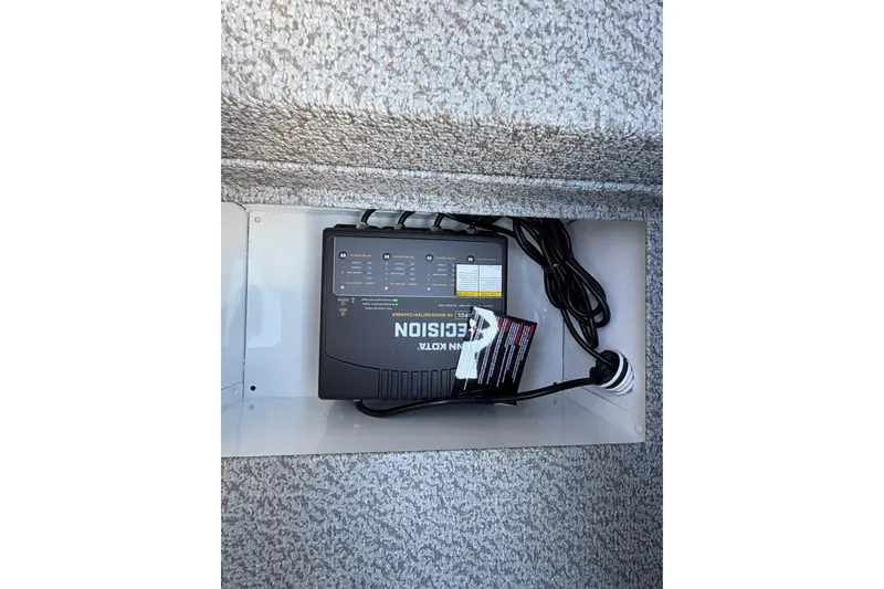 Slide: The Image of Battery charger installed in 2026 Lund 1875 Pro-V Bass XS boat compartment. - 11