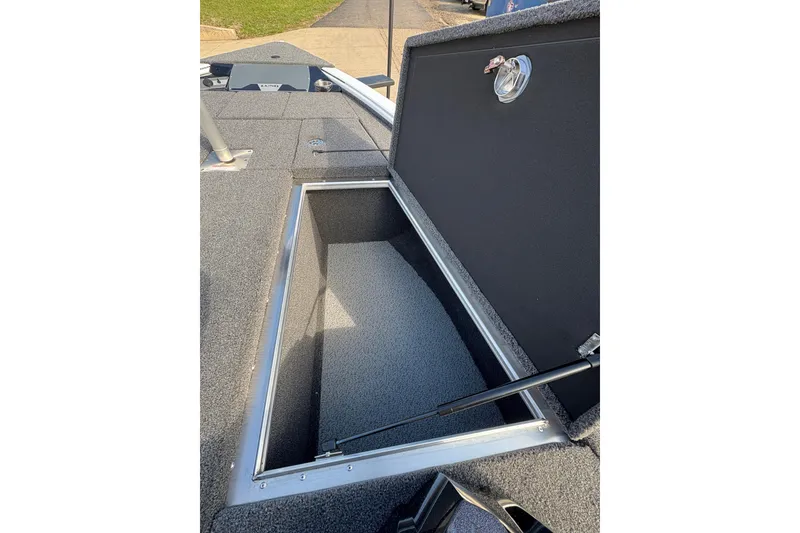 Slide: The Image of Open storage compartment on 2026 Lund 1875 Pro-V Bass XS boat deck. - 13