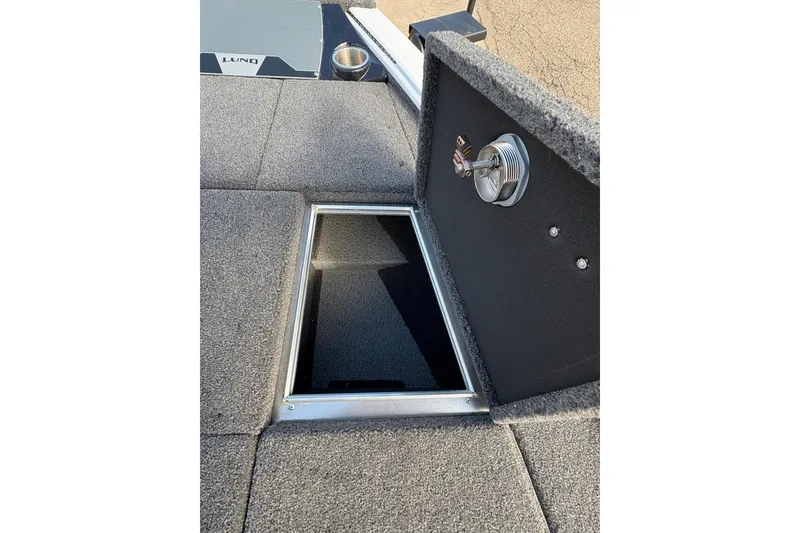 Slide: The Image of Open storage compartment on 2026 Lund 1875 Pro-V Bass XS boat deck. - 14