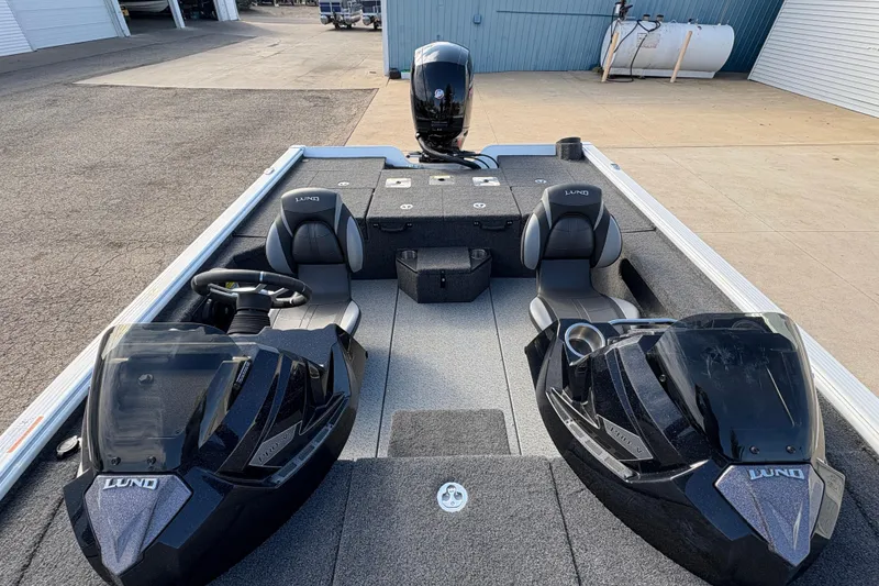 Slide: The Image of 2026 Lund 1875 Pro-V Bass XS boat interior with dual consoles and seating. - 16