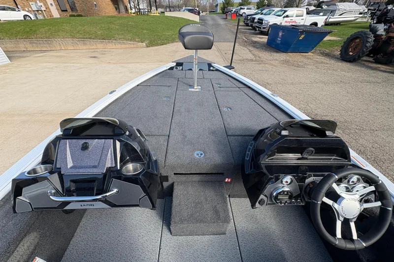 Slide: The Image of 2026 Lund 1875 Pro-V Bass XS boat interior with steering console and seating. - 17