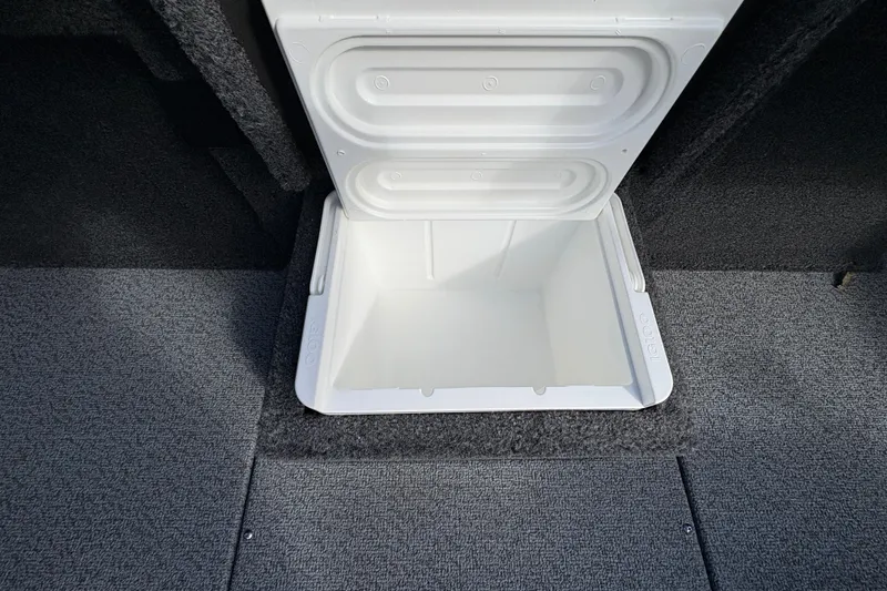 Slide: The Image of Open storage compartment in 2026 Lund 1875 Pro-V Bass XS boat, featuring carpeted flooring. - 18