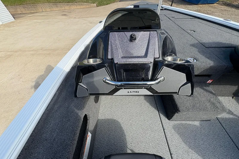 Slide: The Image of 2026 Lund 1875 Pro-V Bass XS boat interior with sleek console and cup holders. - 19