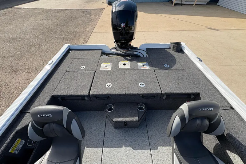 Slide: The Image of 2026 Lund 1875 Pro-V Bass XS boat interior with seating and motor. - 24