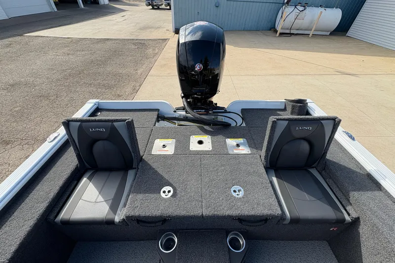 Slide: The Image of 2026 Lund 1875 Pro-V Bass XS boat interior with seating and motor view. - 26
