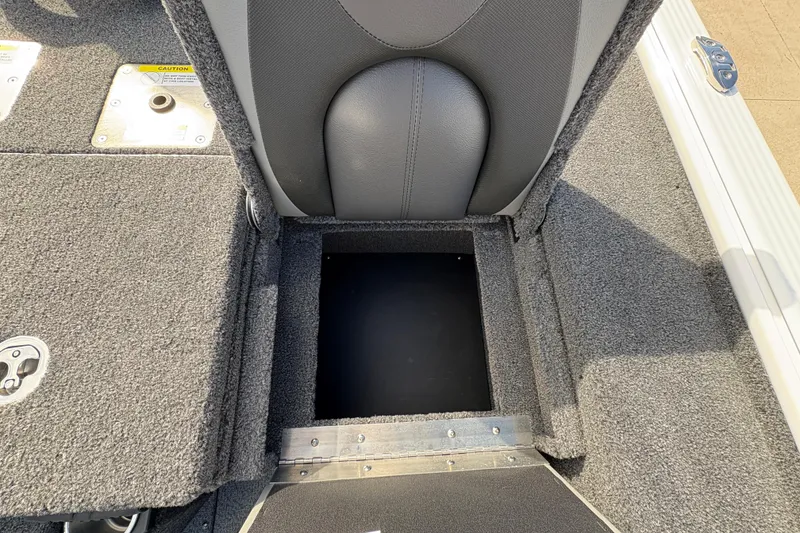 Slide: The Image of 2026 Lund 1875 Pro-V Bass XS boat interior storage compartment with gray upholstery and carpeted flooring. - 29