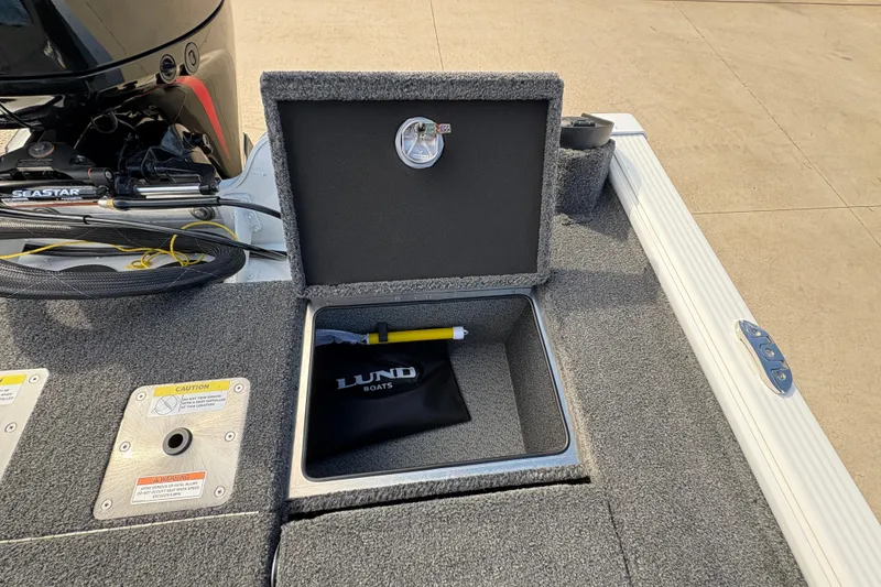 Slide: The Image of Open storage compartment on 2026 Lund 1875 Pro-V Bass XS boat deck. - 31