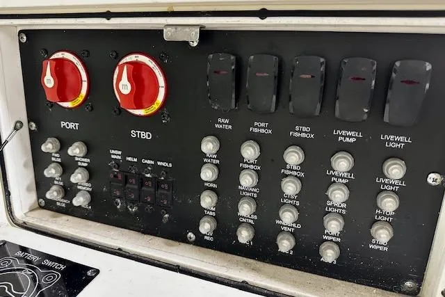 Slide: The Image of Control panel of a 2016 Boston Whaler 285 Conquest boat with switches and dials. - 11