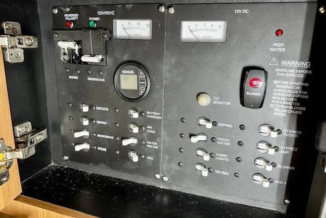 Slide: The Image of Control panel of a 2016 Boston Whaler 285 Conquest boat, featuring various switches and gauges. - 21