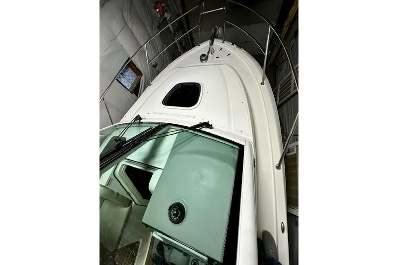 Slide: The Image of 2016 Boston Whaler 285 Conquest boat in storage, showcasing deck and cabin features. - 23