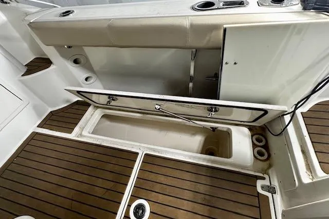 Slide: The Image of 2016 Boston Whaler 285 Conquest boat deck with open storage compartment. - 8