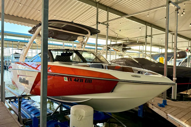 Slide: The Image of 2019 Malibu Wakesetter 23 LSV boat docked in marina. - 12
