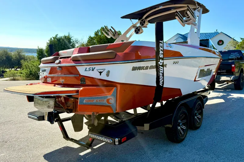 Slide: The Image of 2019 Malibu Wakesetter 23 LSV boat on trailer, rear view, sunny day. - 24
