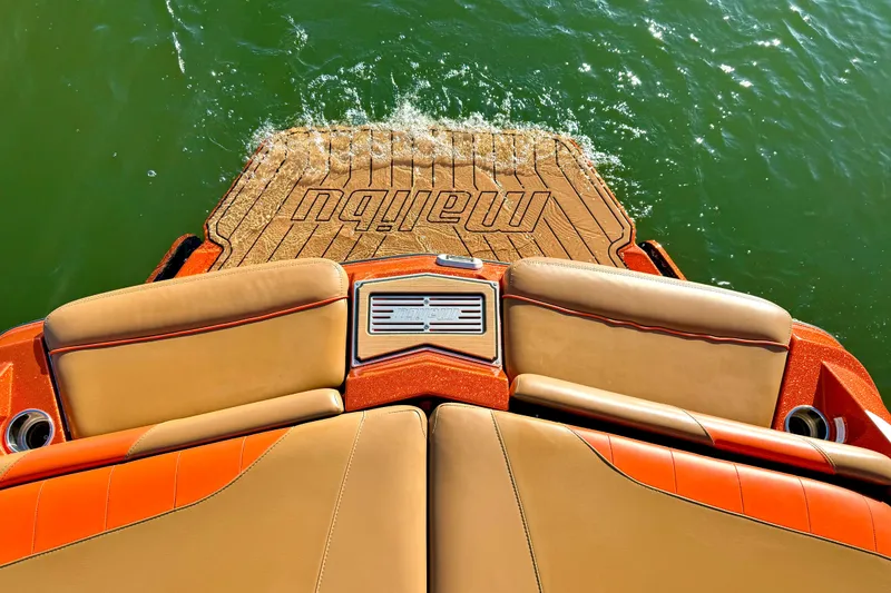 Slide: The Image of 2019 Malibu Wakesetter 23 LSV boat with tan and orange seating on water. - 31