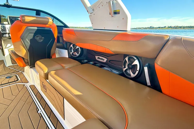 Slide: The Image of 2019 Malibu Wakesetter 23 LSV interior with orange and brown seating, lake view. - 36