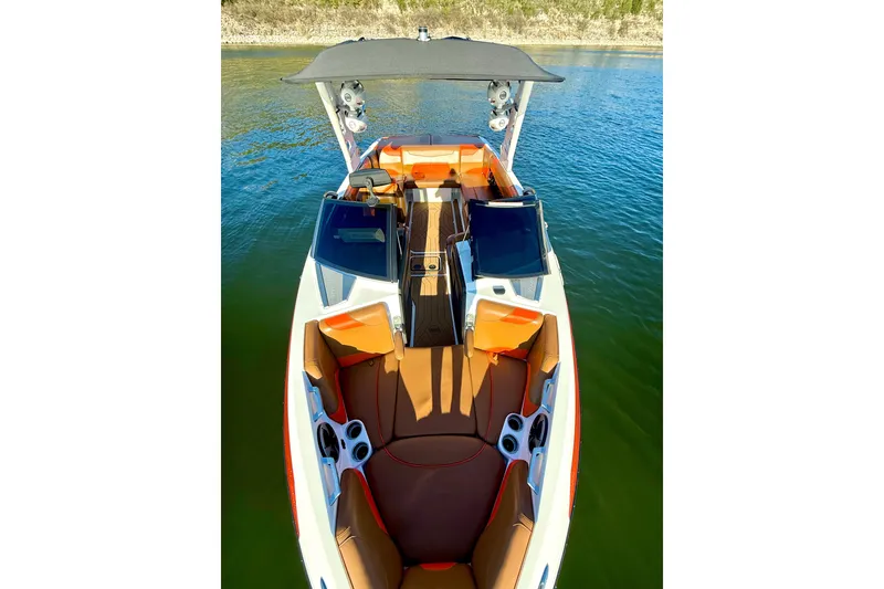 Slide: The Image of 2019 Malibu Wakesetter 23 LSV boat with orange interior on a lake. - 44
