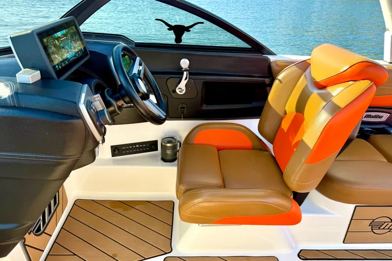 Slide: The Image of 2019 Malibu Wakesetter 23 LSV interior with modern dashboard and orange-brown seating. - 48