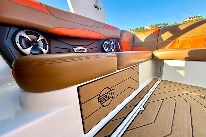 Slide: The Image of 2019 Malibu Wakesetter 23 LSV interior with brown and orange seating, speakers, and logo. - 50