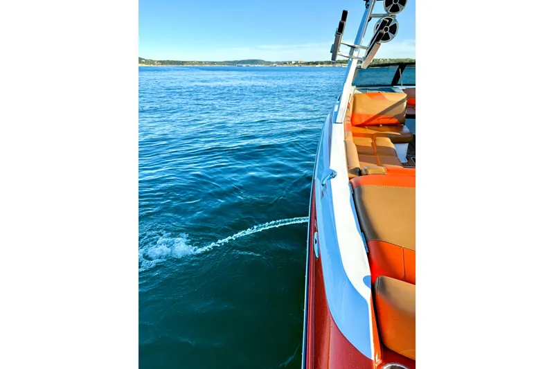 Slide: The Image of 2019 Malibu Wakesetter 23 LSV on calm blue water, showcasing sleek design and vibrant seating. - 51