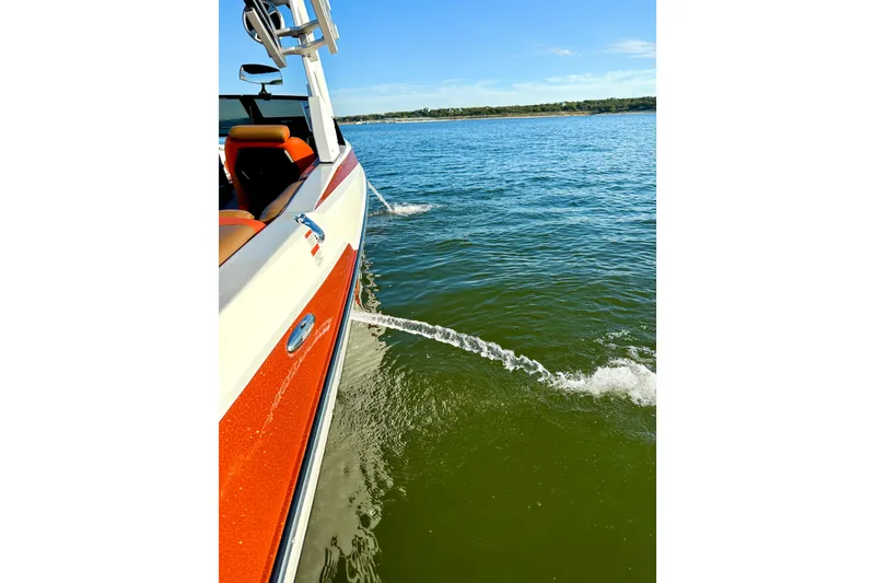 Slide: The Image of 2019 Malibu Wakesetter 23 LSV on a sunny lake, side view with water spray. - 52