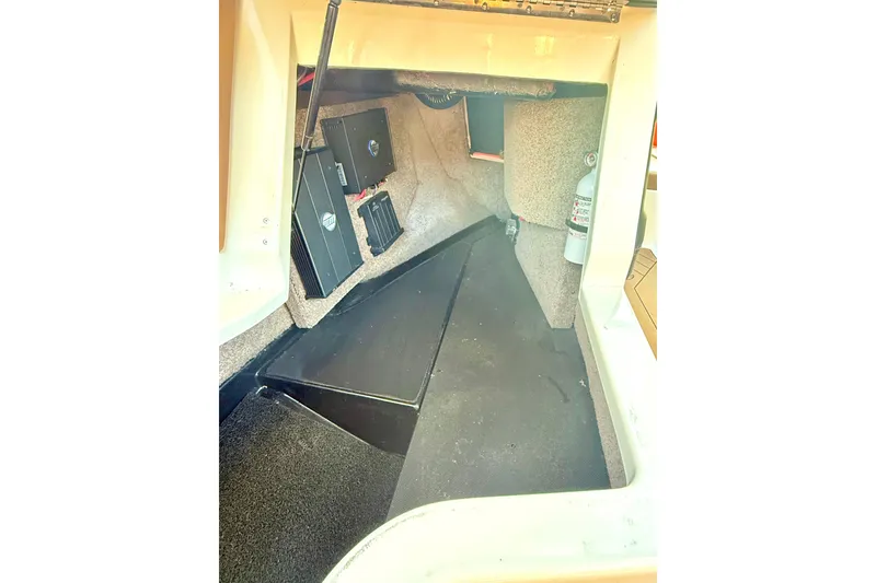 Slide: The Image of 2019 Malibu Wakesetter 23 LSV interior storage compartment with equipment and fire extinguisher. - 53