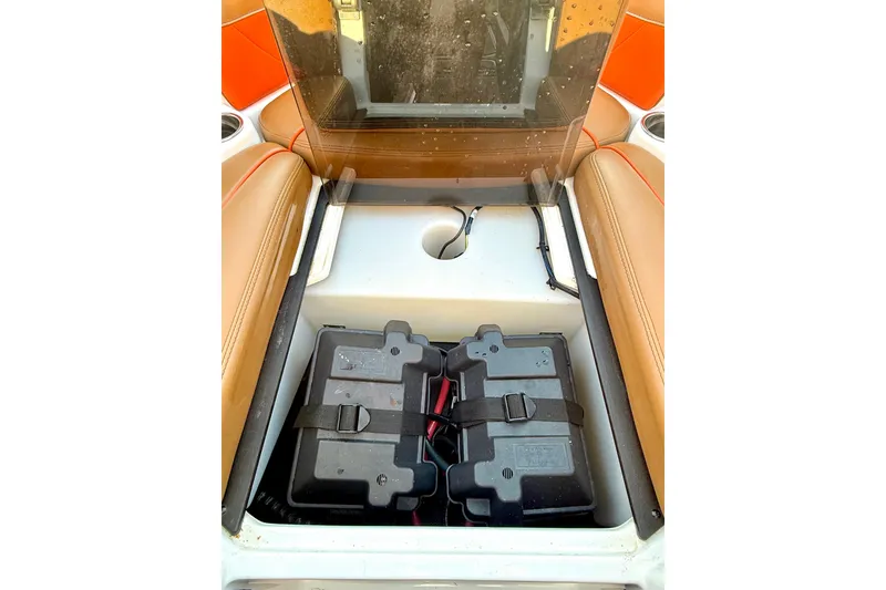 Slide: The Image of 2019 Malibu Wakesetter 23 LSV battery compartment with dual batteries and seating. - 54