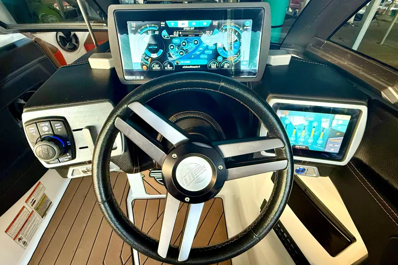 Slide: The Image of 2019 Malibu Wakesetter 23 LSV dashboard with advanced touchscreen controls and steering wheel. - 58