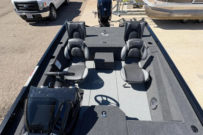 Slide: The Image of 2026 Lund 1875 Renegade boat interior with two seats and steering console. - 14