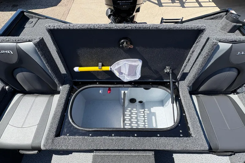 Slide: The Image of 2026 Lund 1875 Renegade boat interior with storage compartment and fishing net. - 20