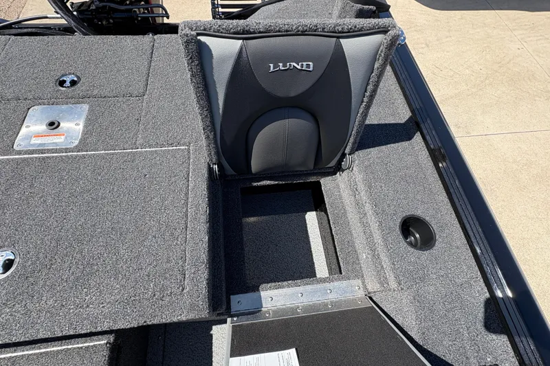 Slide: The Image of 2026 Lund 1875 Renegade boat interior with gray seating and storage compartments. - 23