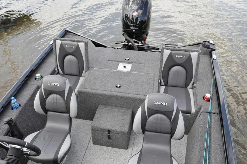 Slide: The Image of Manufacturer Provided Image: 2025 Lund 1875 Renegade boat interior with four seats and motor on water. - 6