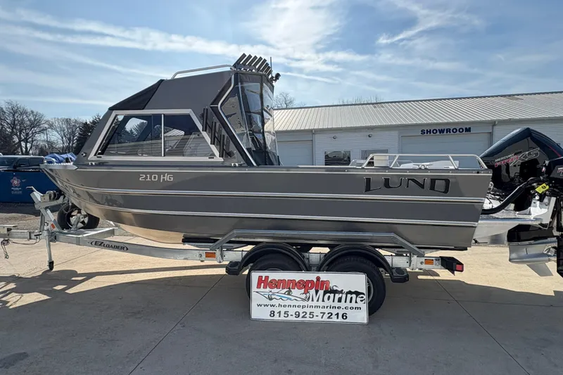 Slide: The Image of 2026 Lund 210 Heavy Gauge boat on trailer at Hennepin Marine showroom. - 16