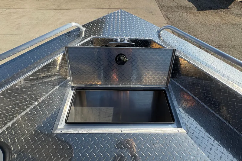 Slide: The Image of Open storage compartment on 2026 Lund 210 Heavy Gauge boat with diamond plate finish. - 19