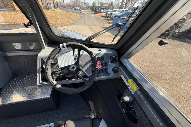 Slide: The Image of Interior view of 2026 Lund 210 Heavy Gauge boat cockpit with steering wheel and controls. - 23