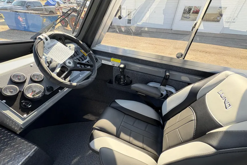 Slide: The Image of Interior of 2026 Lund 210 Heavy Gauge boat with steering wheel and gauges. - 24