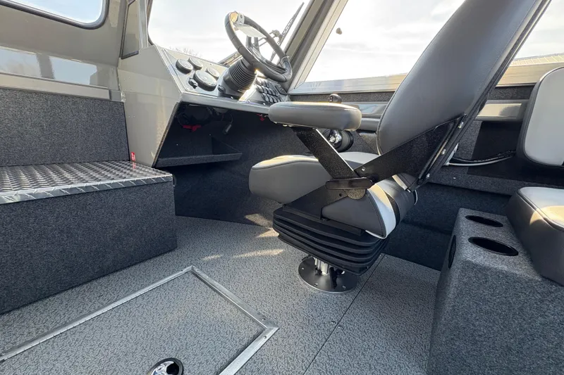 Slide: The Image of Interior of 2026 Lund 210 Heavy Gauge boat with steering wheel and seating. - 30