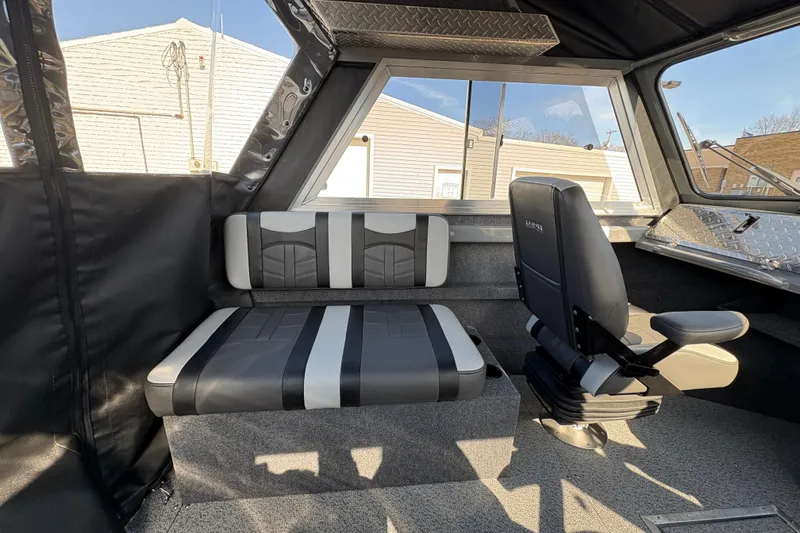 Slide: The Image of Interior of 2026 Lund 210 Heavy Gauge boat with modern seating and windows. - 32