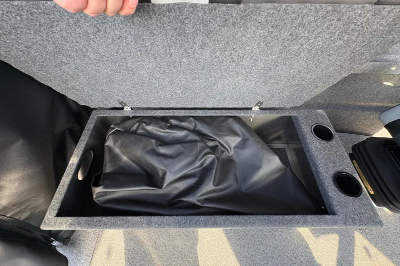 Slide: The Image of Open storage compartment in 2026 Lund 210 Heavy Gauge boat with cup holders. - 33