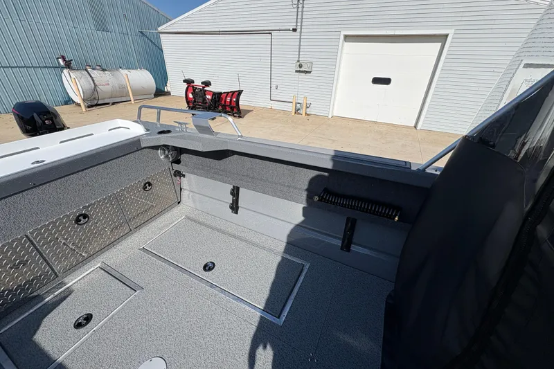 Slide: The Image of Interior of 2026 Lund 210 Heavy Gauge boat, featuring storage compartments and sleek design. - 37