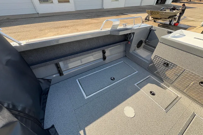 Slide: The Image of 2026 Lund 210 Heavy Gauge boat interior with storage compartments and durable flooring. - 38