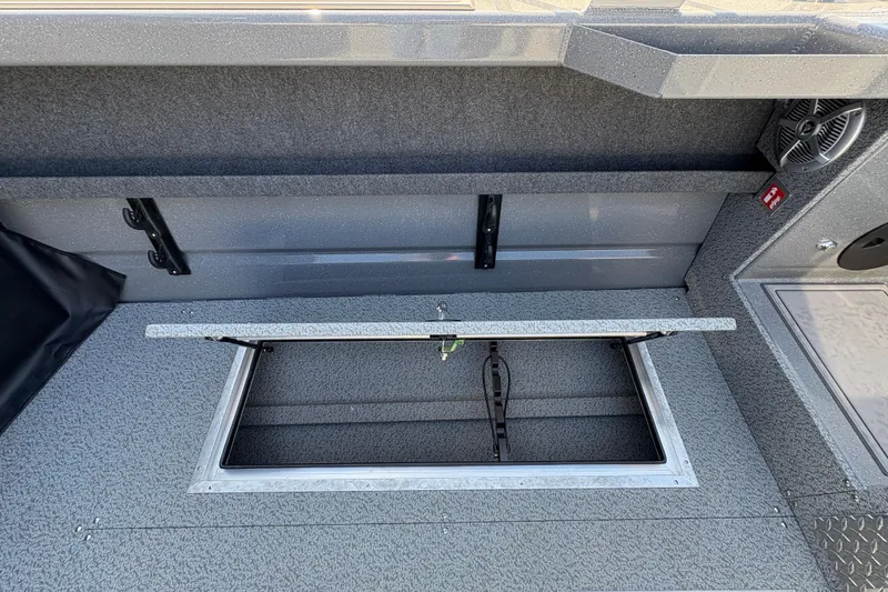 Slide: The Image of 2026 Lund 210 Heavy Gauge boat interior with open storage compartment. - 39