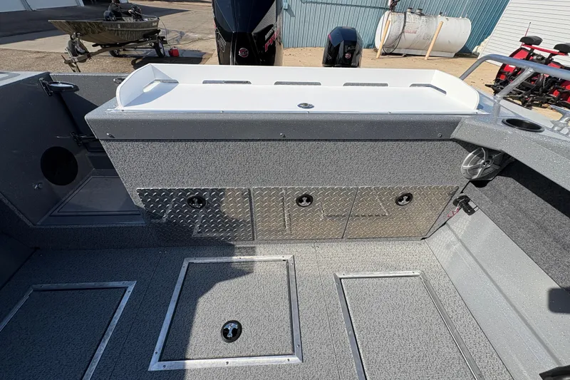 Slide: The Image of 2026 Lund 210 Heavy Gauge boat interior with storage compartments and textured flooring. - 40