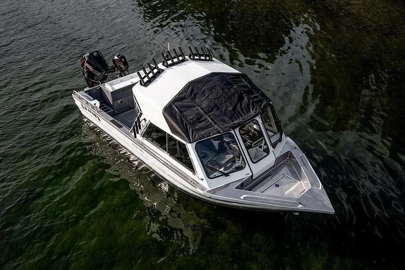 Slide: The Image of Manufacturer Provided Image: 2025 Lund 210 Heavy Gauge boat on water, featuring a sleek design and dual outboard motors. - 56