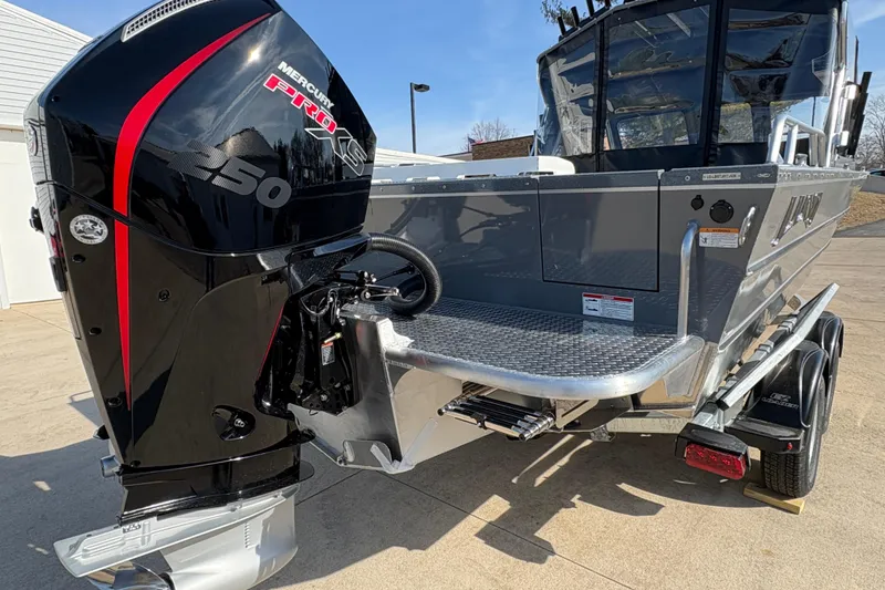 Slide: The Image of 2026 Lund 210 Heavy Gauge boat with Mercury Pro XS 250 engine, parked outdoors. - 8